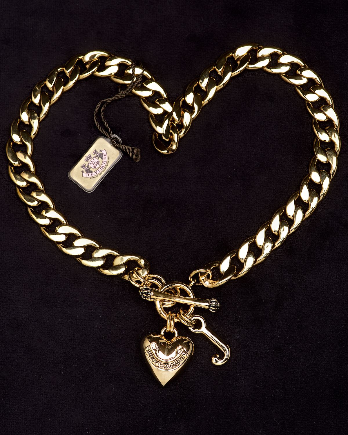 Juicy Couture gold bracelet on black velvet by Bret Doss Commercial Product Photography Seattle