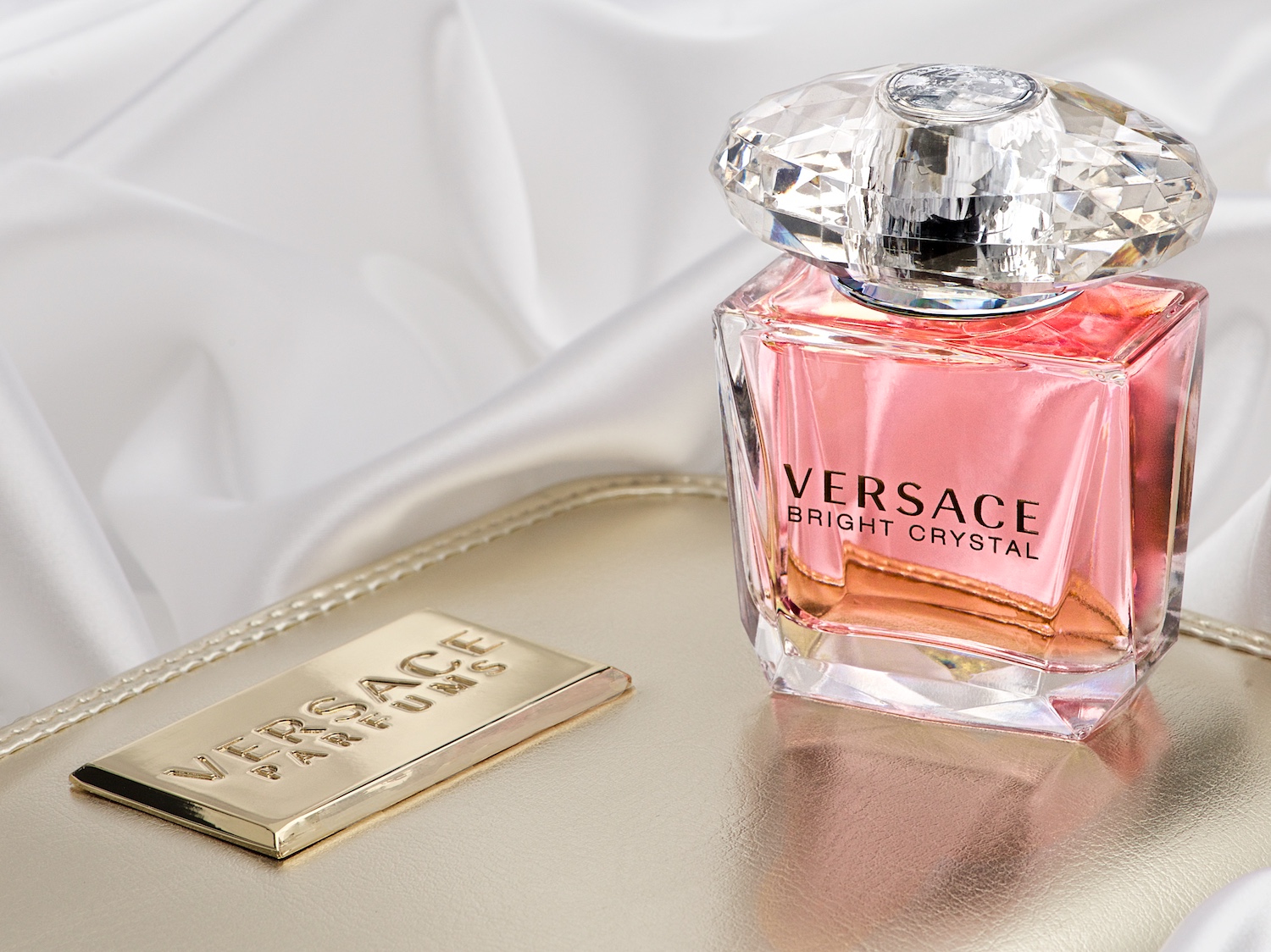 Versace Bright Crystal perfume bottle on gold case and satin by Bret Doss Commercial Product Photography Seattle